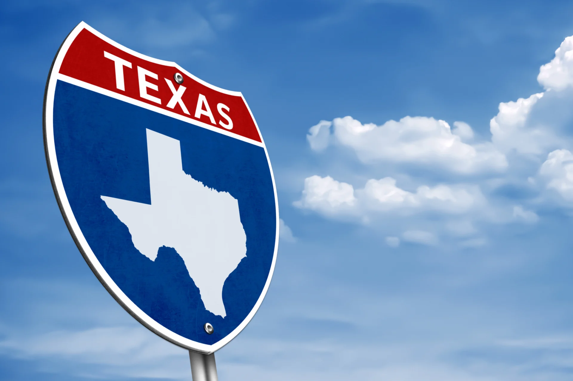 Texas road sign with blue sky background.