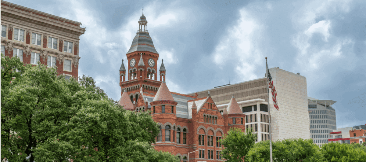 Historic red-brick courthouse with American flag.