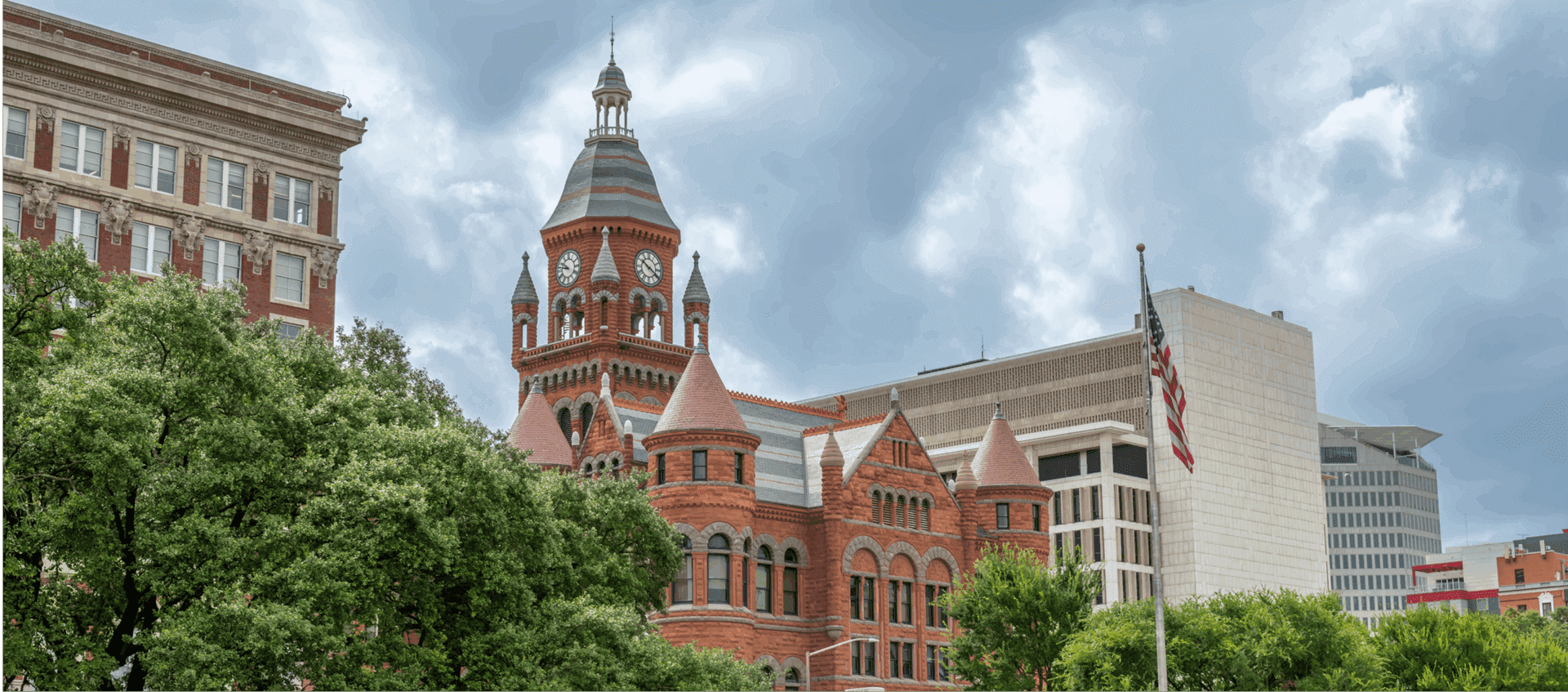 Historic red-brick courthouse with American flag.