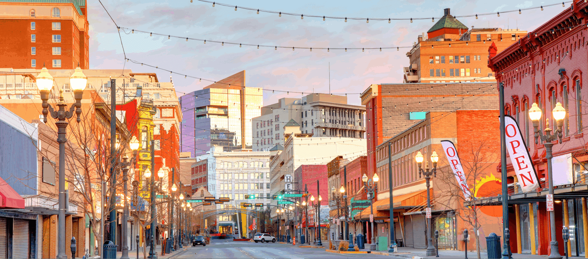 City street with buildings and lights at dusk.