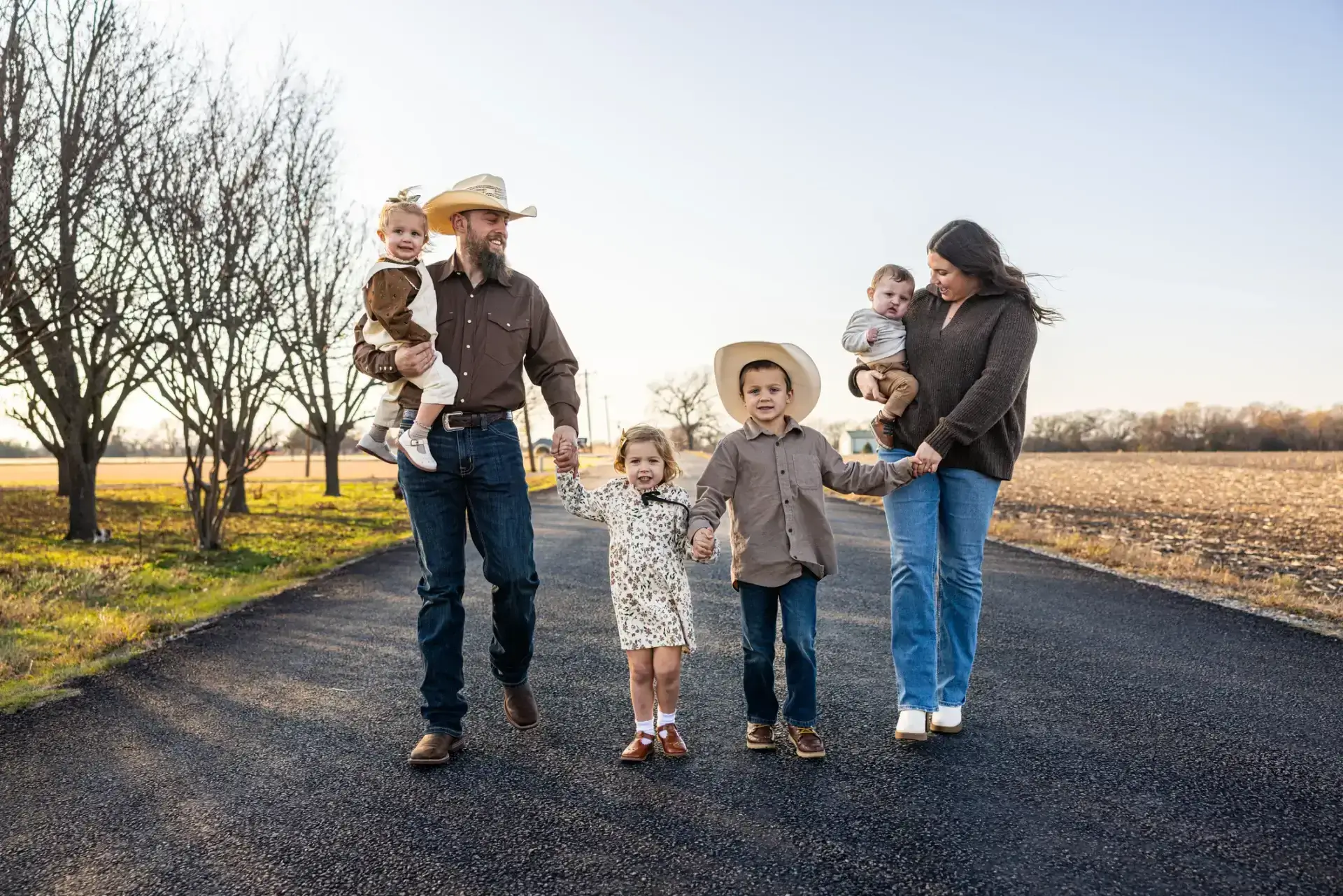 Family walking on a rural road together.