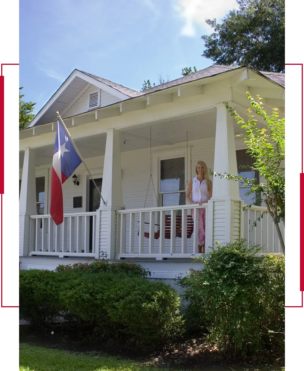 Woman standing on a white porch with a Texas flag.